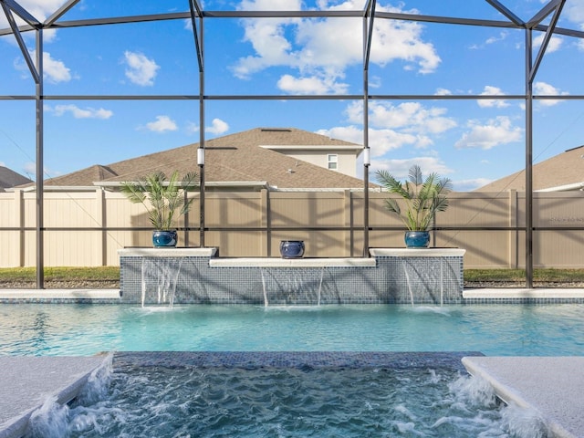 view of swimming pool featuring a lanai, fence, and a fenced in pool