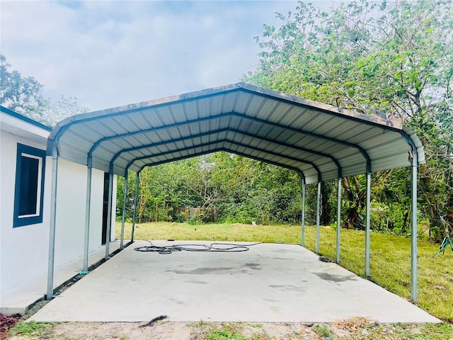 view of parking / parking lot with a lawn and a carport