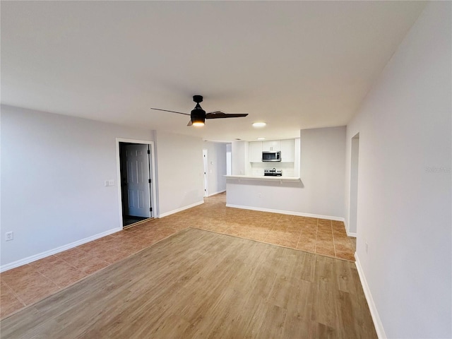 unfurnished living room with light hardwood / wood-style floors and ceiling fan