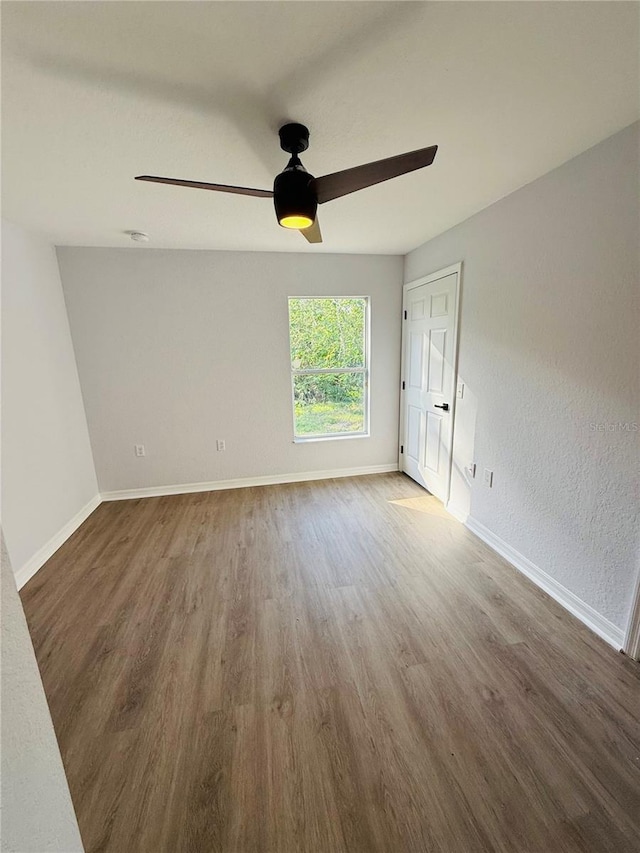 empty room with dark wood-type flooring