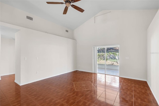 tiled spare room with high vaulted ceiling and ceiling fan