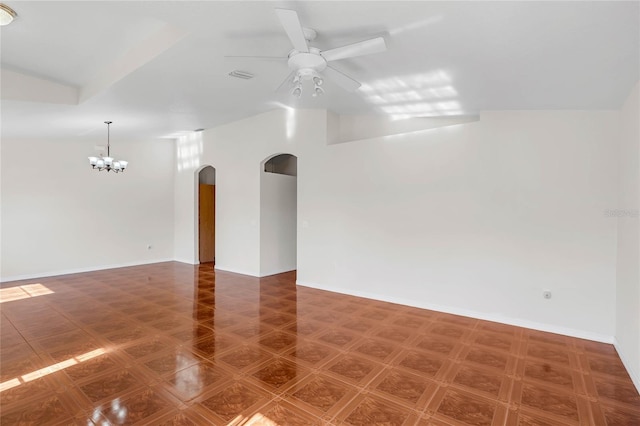 unfurnished room with ceiling fan with notable chandelier and lofted ceiling