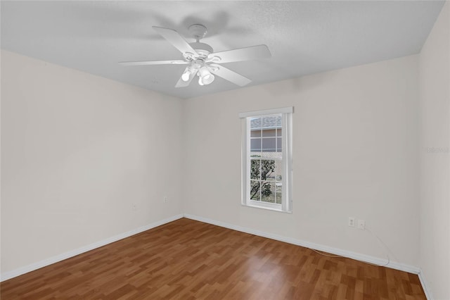 spare room with wood-type flooring and ceiling fan