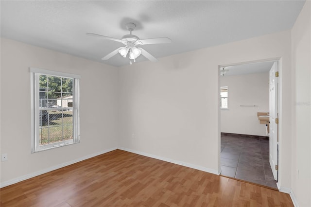 unfurnished room featuring hardwood / wood-style floors and ceiling fan