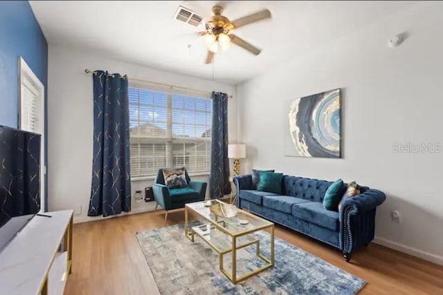 living room featuring ceiling fan and hardwood / wood-style flooring