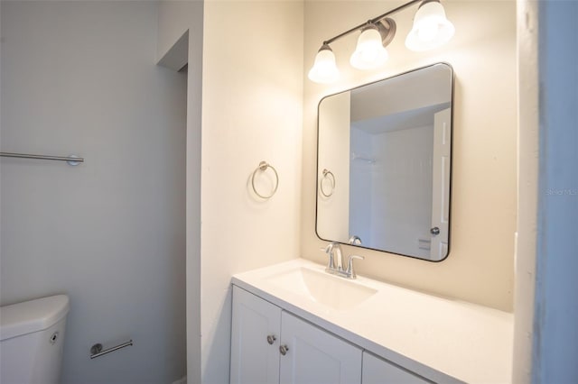 bathroom featuring vanity and toilet