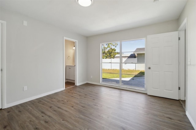 spare room with dark wood-type flooring