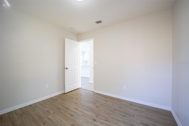 spare room featuring hardwood / wood-style floors