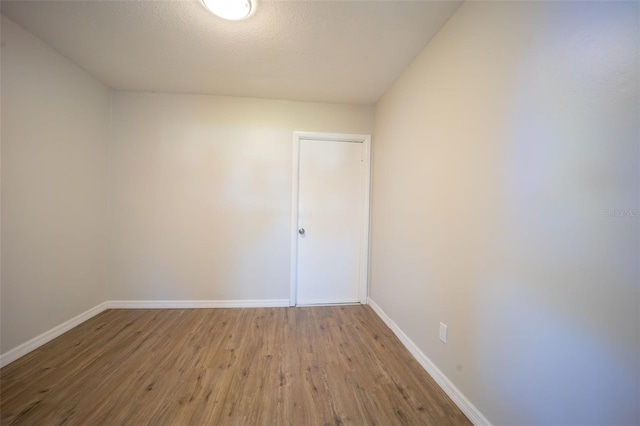 unfurnished room with hardwood / wood-style floors