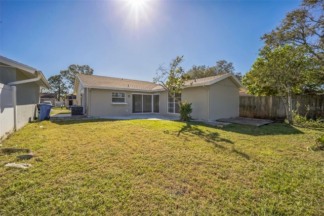 rear view of property featuring a yard