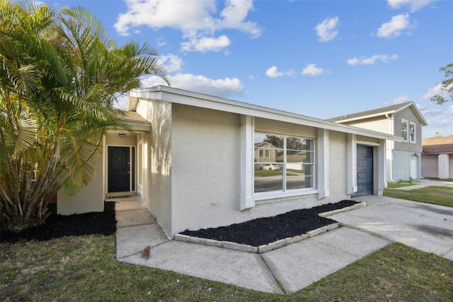 entrance to property with a garage and a yard