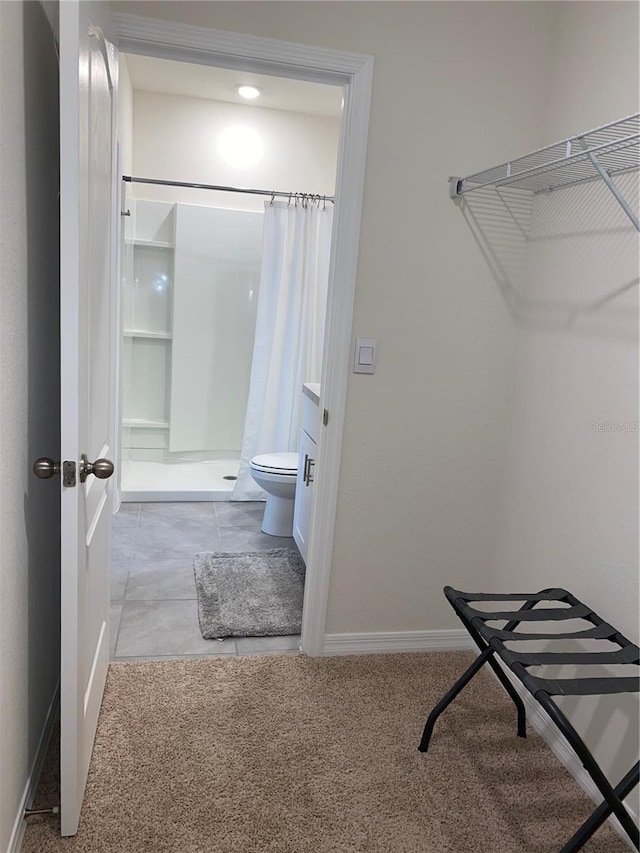 walk in closet featuring light colored carpet