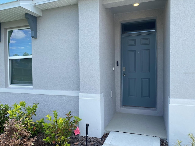 310 Gardenia Ct, Poinciana, FL 34759 - property entrance with stucco siding