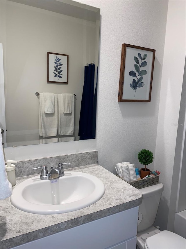 bathroom featuring vanity and toilet