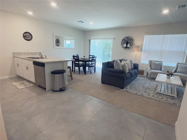 310 Gardenia Ct, Poinciana, FL 34759 - living room with recessed lighting, baseboards, light carpet, and light tile patterned flooring