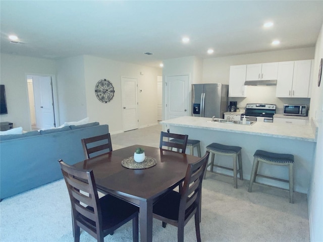 310 Gardenia Ct, Poinciana, FL 34759 - dining room featuring recessed lighting and light carpet