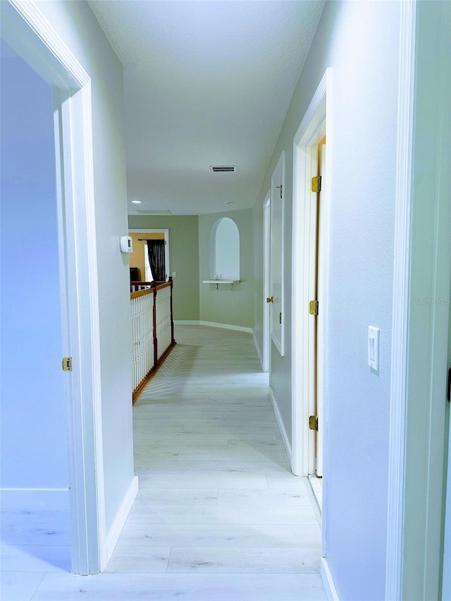 hallway with light hardwood / wood-style flooring