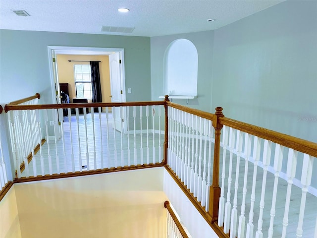 hallway featuring a textured ceiling