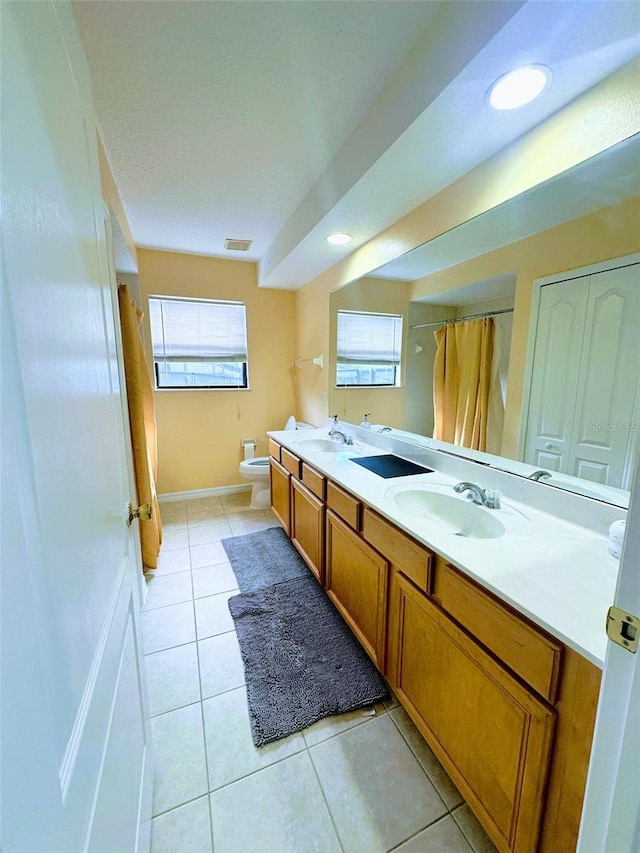 bathroom featuring tile patterned flooring, vanity, and toilet