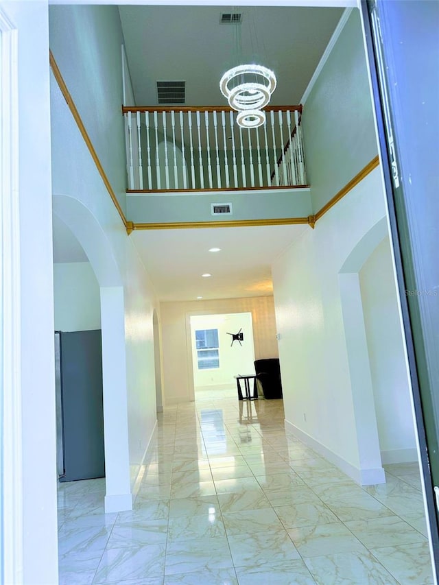 interior space featuring a high ceiling and a notable chandelier