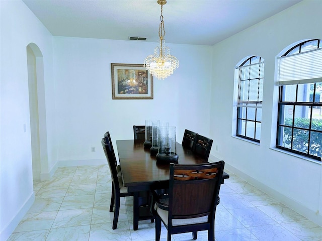 dining area featuring a notable chandelier