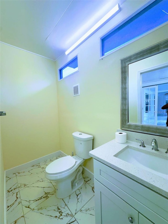 bathroom featuring vanity and toilet