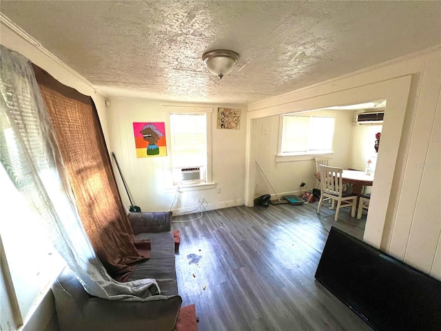 interior space featuring a wall mounted AC, cooling unit, wood-type flooring, and a textured ceiling