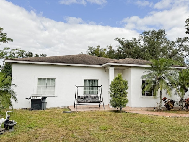 back of house with a yard