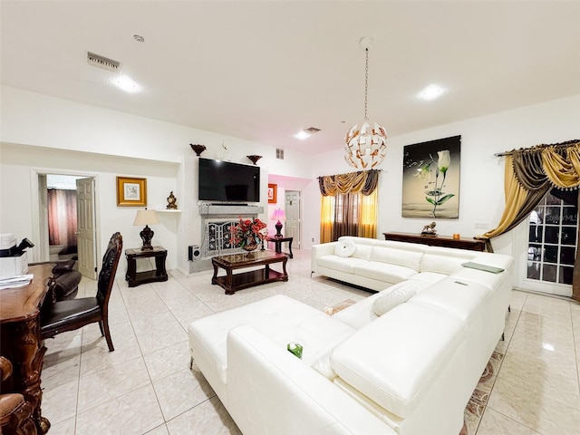 tiled living room featuring an inviting chandelier