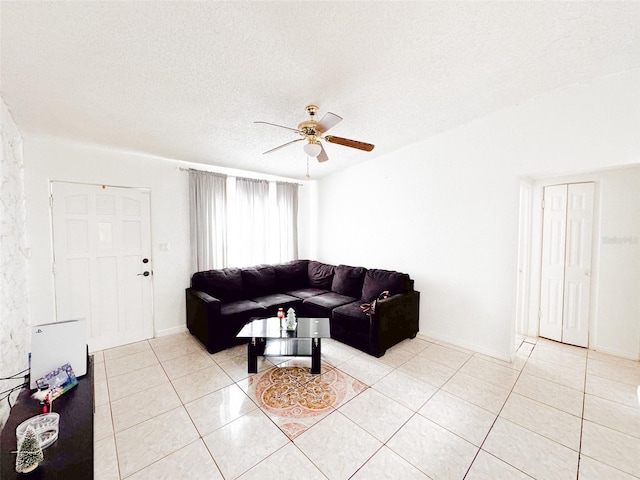 tiled living room with ceiling fan and a textured ceiling