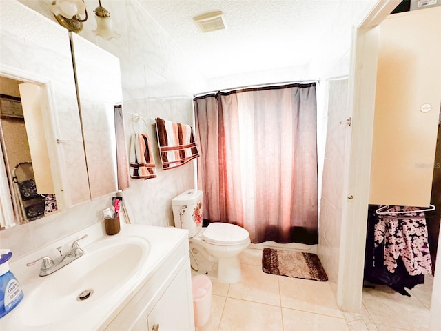 full bathroom featuring shower / bath combo, tile patterned floors, vanity, a textured ceiling, and toilet