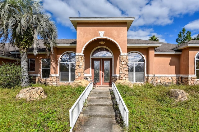 view of exterior entry featuring french doors