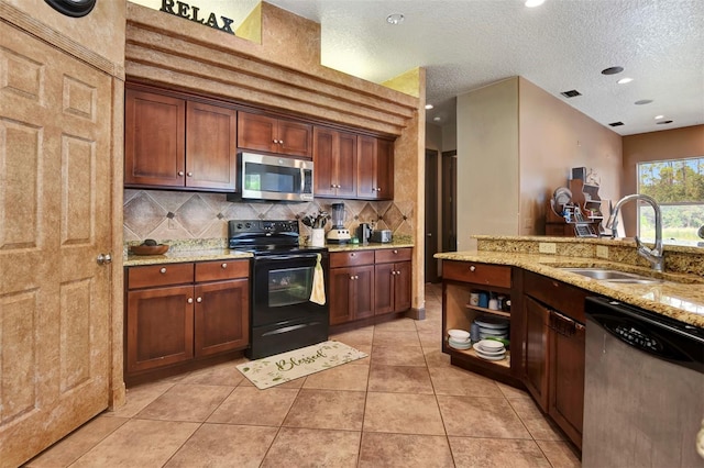 kitchen with light stone counters, a textured ceiling, stainless steel appliances, sink, and light tile patterned flooring