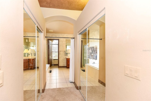 corridor featuring light tile patterned floors