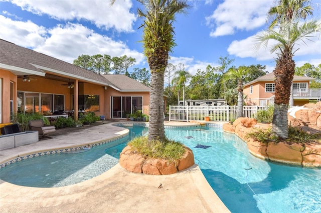 view of pool with a patio area and ceiling fan