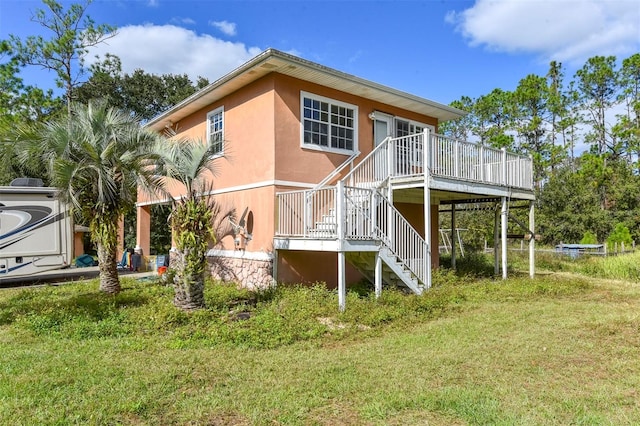 exterior space featuring a lawn and a wooden deck