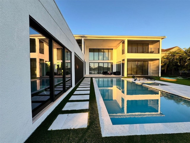 rear view of house featuring a balcony and a patio area