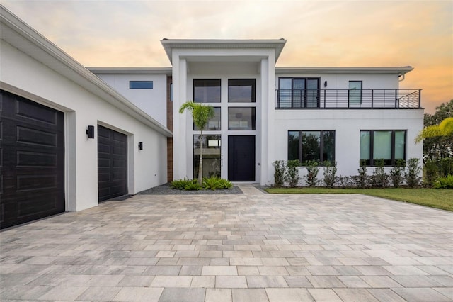 view of front facade with a balcony and a garage