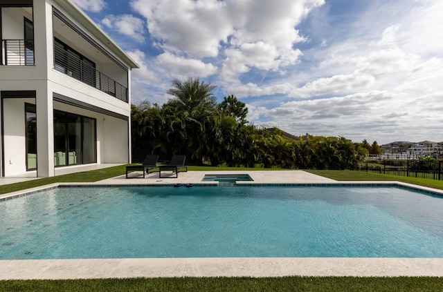 view of pool featuring a patio area and an in ground hot tub