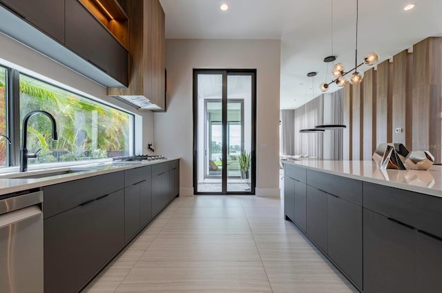 kitchen featuring an inviting chandelier, sink, hanging light fixtures, light tile patterned floors, and stainless steel appliances