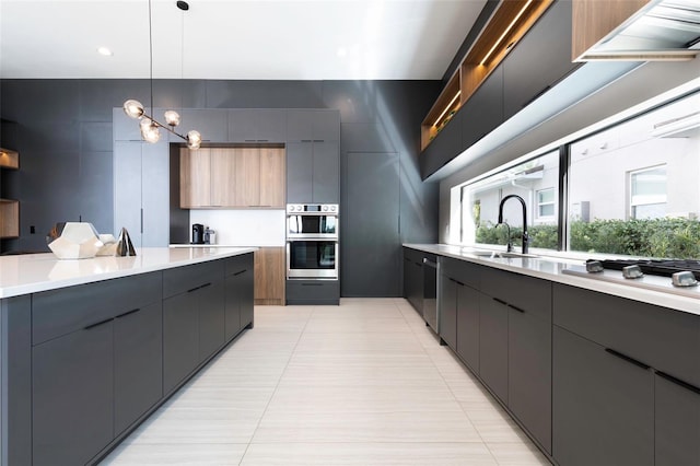 kitchen featuring sink, light tile patterned floors, hanging light fixtures, and stainless steel appliances