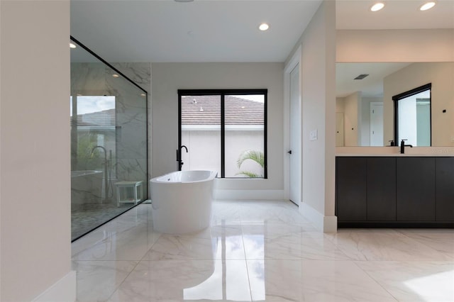 bathroom featuring vanity and shower with separate bathtub