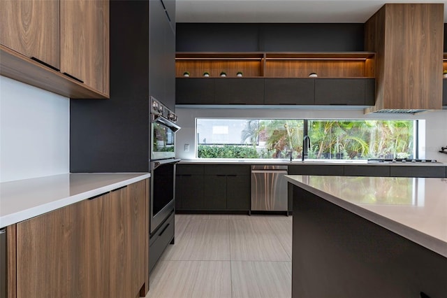 kitchen with sink, light tile patterned floors, and appliances with stainless steel finishes