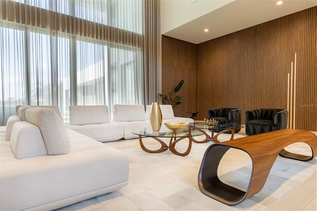 15614 Espalier Way, Winter Garden, FL 34787 - living room featuring recessed lighting, a high ceiling, wood walls, and light floors