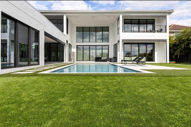 15614 Espalier Way, Winter Garden, FL 34787 - rear view of house with an outdoor pool, a balcony, a patio area, and a lawn