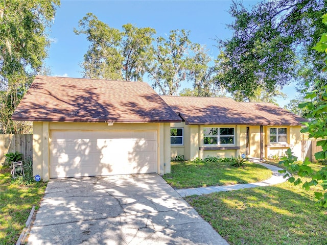 ranch-style home with a garage and a front yard