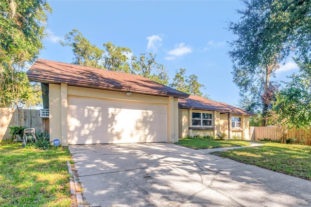 ranch-style house featuring a front lawn and a garage