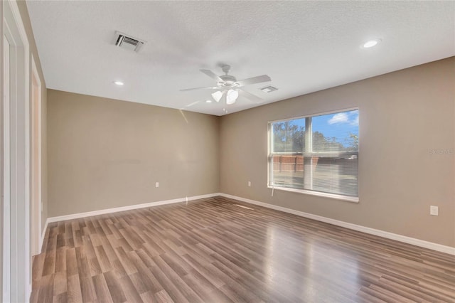 unfurnished room featuring hardwood / wood-style floors, ceiling fan, and a textured ceiling