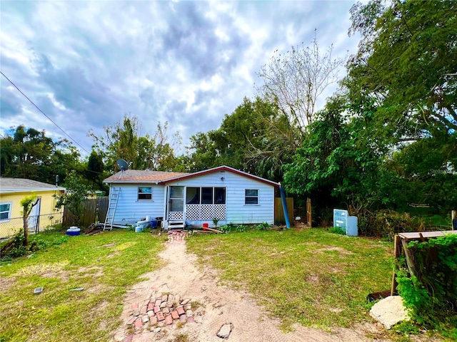 back of house with a lawn