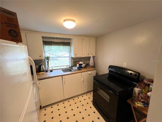 kitchen featuring sink, white cabinets, white refrigerator, and black range with electric cooktop